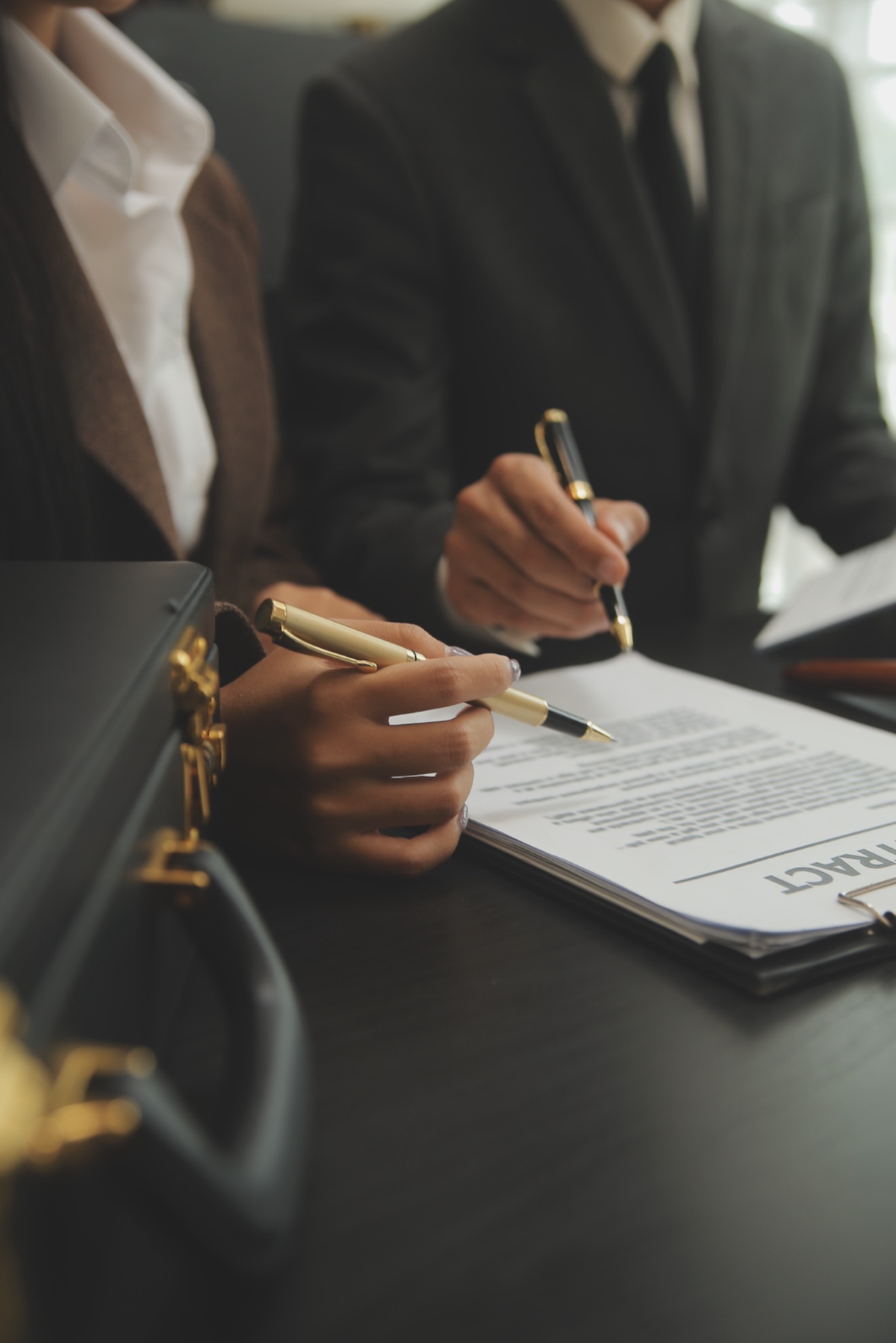 Legal professionals reviewing a contract