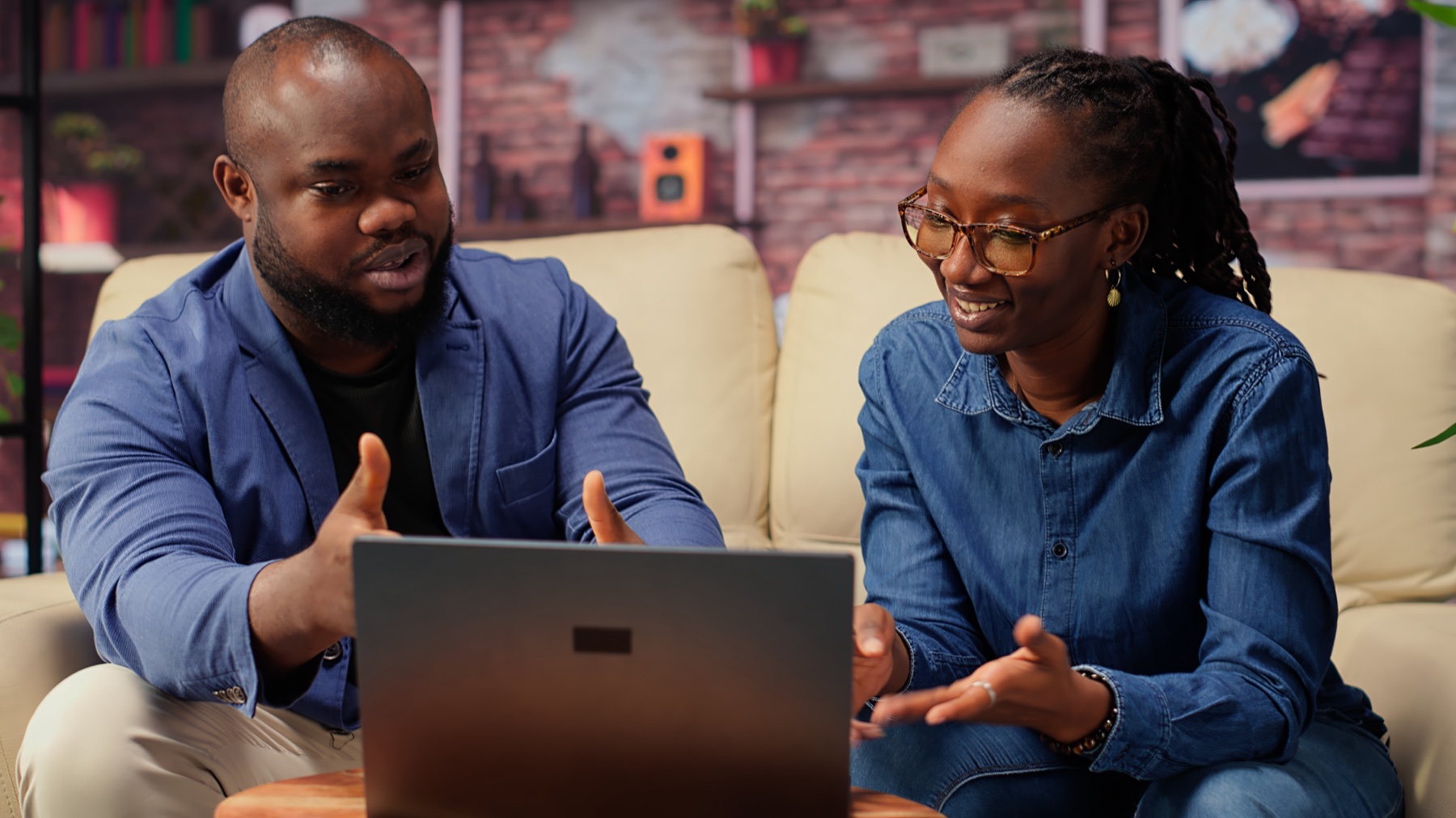 A diverse team collaborating around a laptop